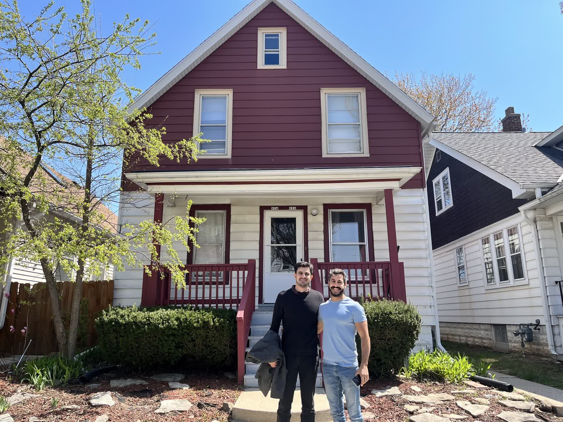 DYS Invest: Two smiling men in front of an investment property, embodying community, growth, and value creation.